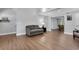 Open-concept living room with wood floors and a view to the dining area, great for entertaining at 115 Braided Blanket Blf, Johns Creek, GA 30022