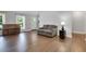 Cozy living room featuring hardwood floors, neutral decor, and a comfortable seating area at 115 Braided Blanket Blf, Johns Creek, GA 30022