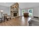 Inviting living room with vaulted ceiling, stone fireplace, and new hardwood floors at 115 Braided Blanket Blf, Johns Creek, GA 30022