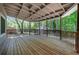 Spacious covered porch with wood decking overlooking green backyard at 115 Braided Blanket Blf, Johns Creek, GA 30022