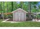 Exterior shot of the backyard shed with small porch area at 115 Braided Blanket Blf, Johns Creek, GA 30022