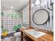 Unique bathroom with wood vanity, metal walls, and shower with patterned curtains at 1943 Scott Rd, Canton, GA 30115