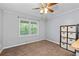 Bedroom with neutral walls, wood-look ceiling fan, large window, and closet system at 1943 Scott Rd, Canton, GA 30115