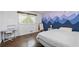 Bright bedroom with a charming mountain mural, stylish furnishings, and beautiful natural light at 1943 Scott Rd, Canton, GA 30115