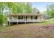 Charming single-story home with a welcoming front porch and well-maintained lawn surrounded by lush greenery at 1943 Scott Rd, Canton, GA 30115