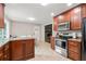 Kitchen space with stainless appliances, granite countertops, dark cabinets and easy access to the fireplace at 1943 Scott Rd, Canton, GA 30115