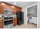 Well-lit kitchen featuring stainless steel appliances, granite countertops, and laundry room access at 1943 Scott Rd, Canton, GA 30115