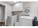 Practical laundry area with sleek front-loading machines, storage and adjacent to the kitchen at 1943 Scott Rd, Canton, GA 30115