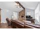 Cozy living room featuring a stone fireplace, exposed beam, hardwood floors, and plenty of natural light at 1943 Scott Rd, Canton, GA 30115