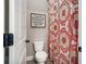 Small bathroom with a toilet, decorative shower curtain, and inspirational wall decor at 2005 Etris Manor Dr, Roswell, GA 30075