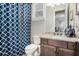 Full bathroom features a stylish vanity, updated fixtures, and patterned shower curtain at 2005 Etris Manor Dr, Roswell, GA 30075