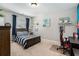 Bedroom with tan carpet, a bed with striped bedding, and stylish wall decor at 2005 Etris Manor Dr, Roswell, GA 30075
