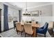Formal dining room features a decorative chandelier, large window, and elegant wainscoting at 2005 Etris Manor Dr, Roswell, GA 30075