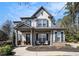 Charming two-story home featuring a welcoming front porch, well-manicured landscaping, and inviting curb appeal at 2005 Etris Manor Dr, Roswell, GA 30075