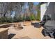 Outdoor fire pit area with stone seating and grill; perfect for gatherings at 2005 Etris Manor Dr, Roswell, GA 30075
