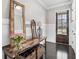 Welcoming foyer with hardwood floors, rustic console table, and ample natural light creating a warm ambiance at 2005 Etris Manor Dr, Roswell, GA 30075