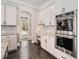 Modern kitchen features white cabinets, stainless steel appliances, and a convenient workspace at 2005 Etris Manor Dr, Roswell, GA 30075
