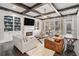 Inviting living room with a fireplace, custom built-ins, coffered ceiling, and large windows, perfect for entertaining at 2005 Etris Manor Dr, Roswell, GA 30075