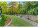 This backyard is well maintained with a manicured lawn, landscaping, and privacy fence at 2582 Corey Park Dr, Loganville, GA 30052