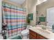 Bathroom featuring a combined shower and bathtub and a wood vanity at 2582 Corey Park Dr, Loganville, GA 30052