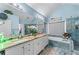 This primary bath has a double sink vanity, marble countertops, and a large soaking tub with a shower at 2582 Corey Park Dr, Loganville, GA 30052