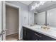 Bathroom featuring a double sink vanity, stylish fixtures, and an open doorway at 2582 Corey Park Dr, Loganville, GA 30052