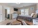 Well-lit bedroom with a large window, comfortable bed, and dresser with decor at 2582 Corey Park Dr, Loganville, GA 30052