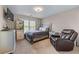 Bedroom featuring a queen size bed and a leather recliner at 2582 Corey Park Dr, Loganville, GA 30052
