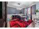 Elegant dining room features a modern chandelier, dark-gray walls, and a striking black and red rug at 2582 Corey Park Dr, Loganville, GA 30052