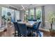 Comfortable dining room with blue upholstered chairs and a marble-top table, bathed in natural light at 2582 Corey Park Dr, Loganville, GA 30052
