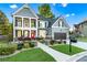 Beautifully landscaped front yard with a two-story home, featuring a red front door and a two-car garage at 2582 Corey Park Dr, Loganville, GA 30052