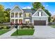 Charming two-story home featuring a manicured front yard, a red front door, and a two-car garage at 2582 Corey Park Dr, Loganville, GA 30052