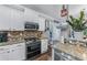 Modern kitchen with granite countertops, stainless steel appliances, and white cabinetry at 2582 Corey Park Dr, Loganville, GA 30052