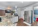 Open kitchen with granite countertops, stainless steel appliances, and a double sink at 2582 Corey Park Dr, Loganville, GA 30052
