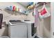 Convenient laundry room with modern washer and dryer units and ample shelving at 2582 Corey Park Dr, Loganville, GA 30052