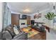 The living room includes modern furniture, a fireplace, a TV, hardwood floors, and a colorful rug at 2582 Corey Park Dr, Loganville, GA 30052