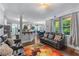 This open concept living room shows modern furniture, hardwood floors, lots of light, and a breakfast bar at 2582 Corey Park Dr, Loganville, GA 30052