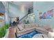 Open living room with two-story ceiling, light-blue walls, and a comfortable sectional sofa at 2582 Corey Park Dr, Loganville, GA 30052