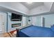 This primary bedroom has a modern fireplace, tray ceilings, and access to an outdoor balcony at 2582 Corey Park Dr, Loganville, GA 30052