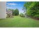 Expansive grassy backyard, ideal for recreation and relaxation with mature trees at 3110 Royal Troon, Woodstock, GA 30189