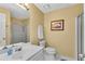 Neutral toned bathroom with a white vanity, framed mirror, and a glass shower enclosure at 3110 Royal Troon, Woodstock, GA 30189