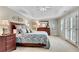 Light-filled primary bedroom featuring neutral carpet, tray ceiling, and french doors to the balcony at 3110 Royal Troon, Woodstock, GA 30189