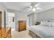 This bedroom features a ceiling fan, windows with shutters and view into a bathroom at 3110 Royal Troon, Woodstock, GA 30189