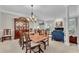 Formal dining room with a large wooden table, china cabinet, and elegant chandelier at 3110 Royal Troon, Woodstock, GA 30189