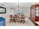 Formal dining room with a large table, china cabinet, and chandelier at 3110 Royal Troon, Woodstock, GA 30189