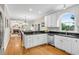 Bright kitchen with white cabinets, dark countertops, and stainless steel appliances overlooking eat-in area at 3110 Royal Troon, Woodstock, GA 30189