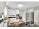 Updated kitchen features white cabinetry, granite countertops, and modern stainless steel appliances at 3110 Royal Troon, Woodstock, GA 30189