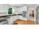 Updated kitchen features white cabinetry, granite countertops, and modern stainless steel appliances at 3110 Royal Troon, Woodstock, GA 30189