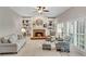 Cozy living room with a brick fireplace, built-in bookshelves, and natural light at 3110 Royal Troon, Woodstock, GA 30189