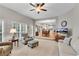 Living room with hardwood floors, fireplace, neutral paint, large windows, and open layout at 3110 Royal Troon, Woodstock, GA 30189